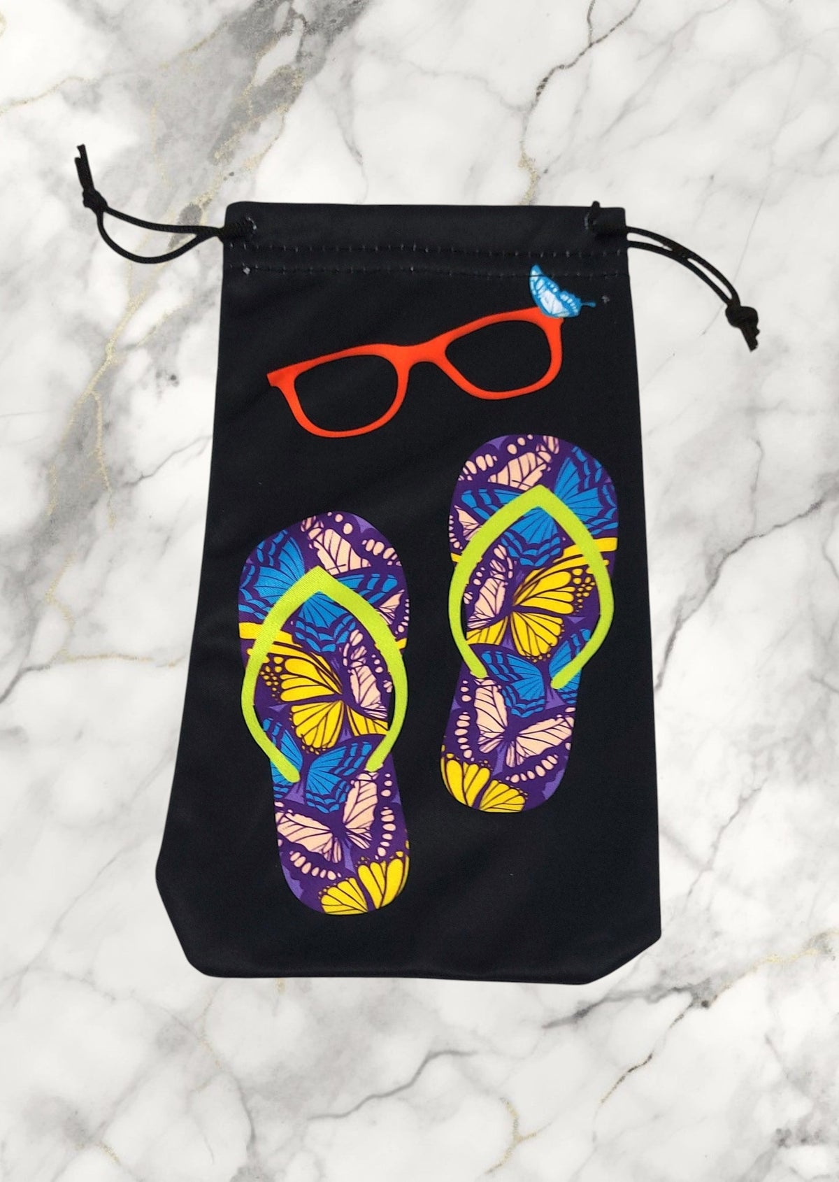 Pochette Jovettine Éco-Bijoux noire en microfibre avec motif tongs papillons et lunettes, fermeture à cordon